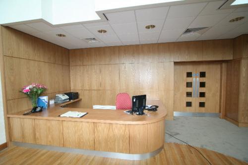 wooden reception desk with curved edge