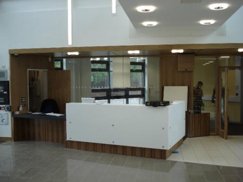 white and wood grain reception desk