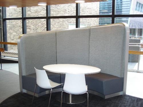 white chairs and table with grey asymmetric sofa