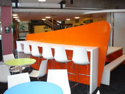 tall bar with seats and orange backing