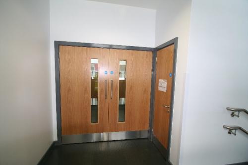 wooden double doors with windows and metal frame